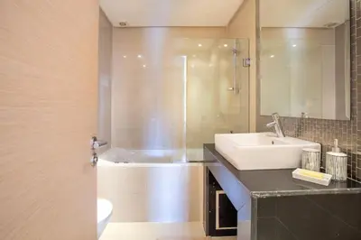 a bathroom with a sink and a bath tub at Heavenly Setting at Prestigia Pool in Marrakech