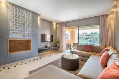 a living room with a couch and a fireplace at Heavenly Setting at Prestigia Pool in Marrakech
