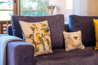 a blue couch with two pillows on it at Serenity and Confort in Prestigia 10 min du centre in Marrakech