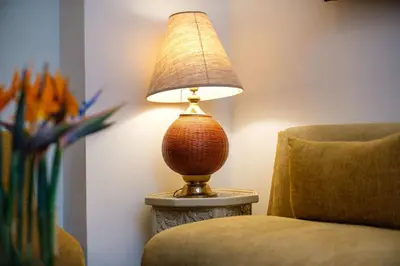a lamp sitting on a table next to a chair at Riad Grenade Exclusif Front Bahia in Marrakech