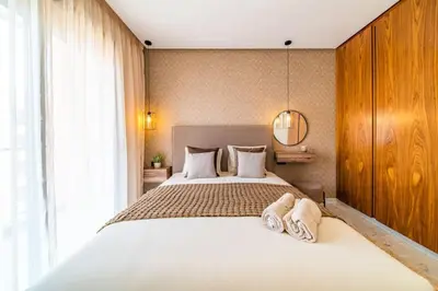 a bedroom with a bed with two towels on it at Cute and Modern in Heart of Downtown in Marrakech
