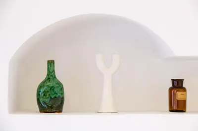 a white vase and a bottle on a shelf at Riad Ines 10mn to Place with Breakfast in Marrakech