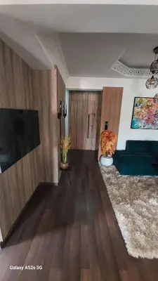 a living room with a couch and a flat screen tv at Elegant room in luxury apartment Gueliz in Marrakech