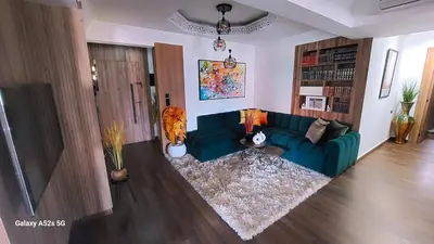 a living room with a blue couch and a rug at Elegant room in luxury apartment Gueliz in Marrakech