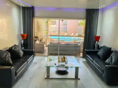 a living room with two couches and a table at Luxury Appartement in Marrakech