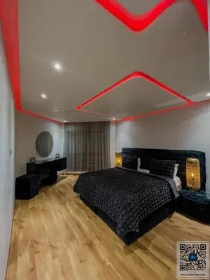 a bedroom with a bed with a red ceiling at Luxury Appartement in Marrakech