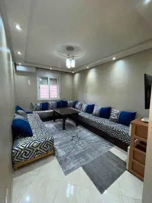 a living room with a couch and a table at Appartement Zen in Marrakech