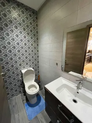a bathroom with a toilet and a sink at Appartement Zen in Marrakech