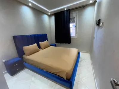 a small bedroom with a blue bed in a room at Appartement Zen in Marrakech
