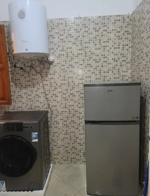 a kitchen with a refrigerator and a washing machine at Authentic stay 2 in Marrakech Comfort & Charm in Marrakech