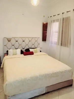a bedroom with a large bed with a white bedspread at Authentic stay 2 in Marrakech Comfort & Charm in Marrakech
