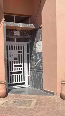 an entrance to a building with a white door at Appartement a les portes de gueliz in Marrakech