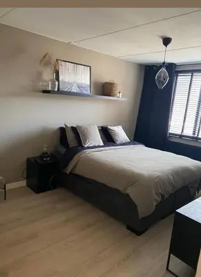 a bedroom with a large bed and a window at Appartement a les portes de gueliz in Marrakech