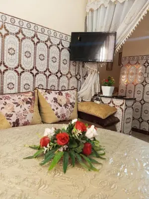 a bouquet of flowers sitting on top of a bed at Large 1-Bed Apt, Perfect for You! in Marrakech