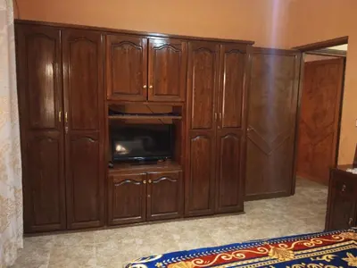 a large wooden cabinet with a tv in it at Large 1-Bed Apt, Perfect for You! in Marrakech