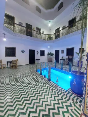 a large room with a swimming pool in a building at Riad Zaid in Marrakech