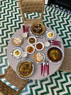 a table with many plates of food on it at Riad Zaid in Marrakech