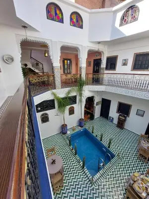 a house with a swimming pool in the middle of it at Riad Zaid in Marrakech