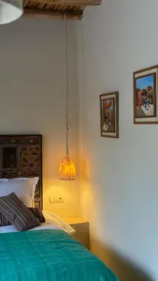 a bedroom with a bed and a lamp in it at Riad des Sources in Marrakech