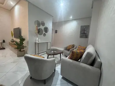 a living room with two chairs and a couch at IMMOB Zak in Marrakech