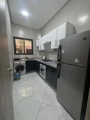 a kitchen with a refrigerator and a washer and dryer at IMMOB Zak in Marrakech