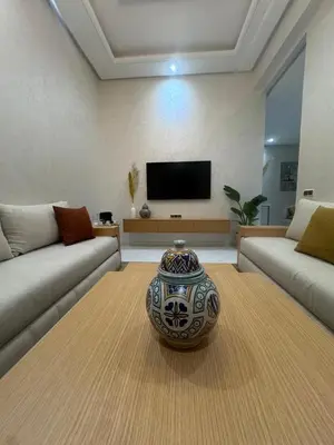 a living room with a vase sitting on a rug at IMMOB Zak in Marrakech