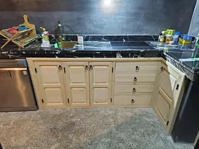 a kitchen with wooden cabinets and a counter top at Riad Palais Bahia - Entire House - 5 Bedrooms in Marrakech
