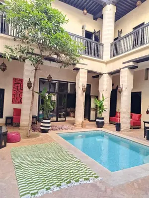 a pool in the courtyard of a house at Riad Palais Bahia - Entire House - 5 Bedrooms in Marrakech