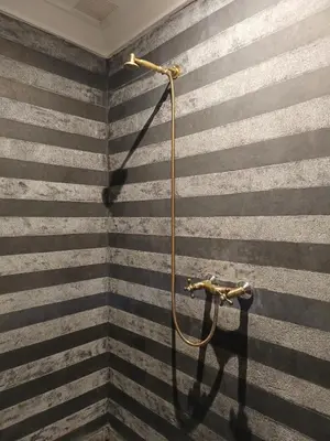 a shower in a bathroom with black and grey stripes at Riad Palais Bahia - Entire House - 5 Bedrooms in Marrakech