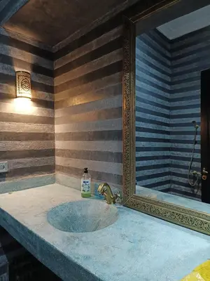 a bathroom with a sink and a mirror at Riad Palais Bahia - Entire House - 5 Bedrooms in Marrakech