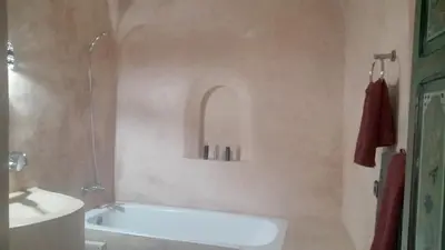 a bathroom with a bath tub and a sink at Riad Maizie in Marrakech