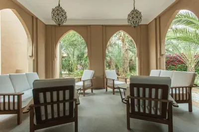 a waiting room with white chairs and windows at Villa Le Perroquet Bleu in Marrakech
