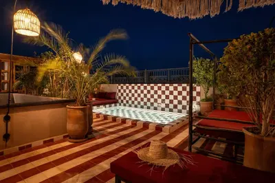 a patio with a bench and a table at Riad Tassili Boutique in Marrakech