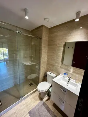 a bathroom with a toilet and a shower and a sink at Exceptional Golf View Apartment, Prestigia in Marrakech