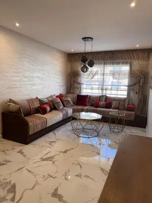 a living room with a couch and a table at Appartement Naïel Palmeraie avec piscine in Marrakech