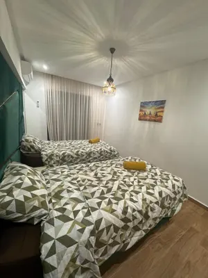 a bedroom with two beds in a room at Appartement Naïel Palmeraie avec piscine in Marrakech