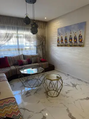 a living room with a couch and a table at Appartement Naïel Palmeraie avec piscine in Marrakech