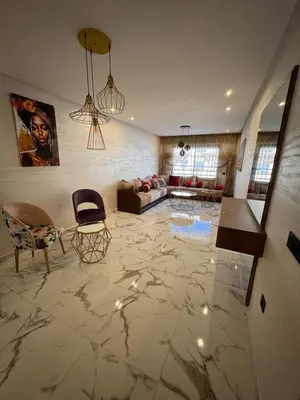 a living room with a marble floor with chairs and a couch at Appartement Naïel Palmeraie avec piscine in Marrakech