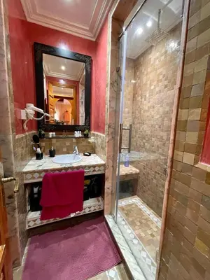 a large bathroom with a sink and a shower at Appartement à Marrakech in Marrakech