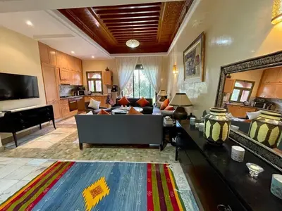 a large living room with a couch and a piano at Appartement à Marrakech in Marrakech