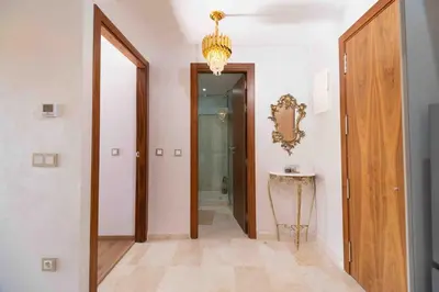 a hallway with a door and a chandelier at Perl garden in Marrakech