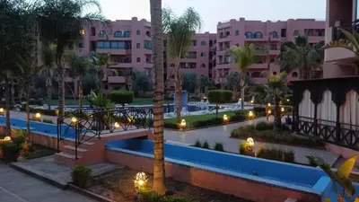 a view of a resort with a pool and buildings at beautiful appartment Premium village in Marrakech
