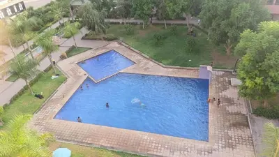 an overhead view of a large swimming pool with people in it at beautiful appartment Premium village in Marrakech