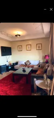 a living room with a couch and a table at beautiful appartment Premium village in Marrakech