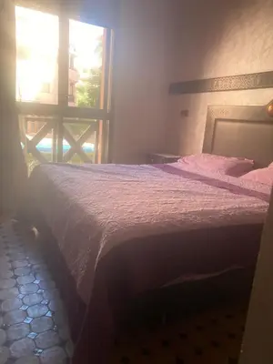 a bedroom with a bed and a window at beautiful appartment Premium village in Marrakech
