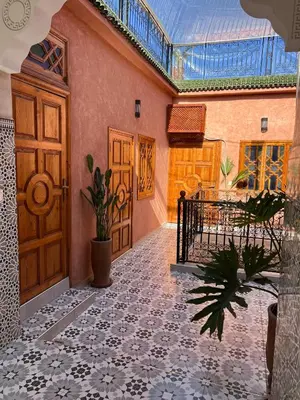 a hallway with a door and a tile floor at Riad dar lakbira in Marrakech