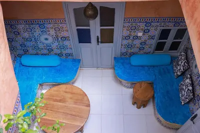a room with two blue chairs and a table at Maison Imane Marrakech in Marrakech