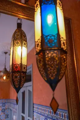 two chandeliers in front of a mirror in a room at Maison Imane Marrakech in Marrakech