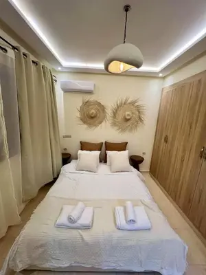a bedroom with a bed with two towels on it at T1 Chic & Bright in Marrakech in Marrakech