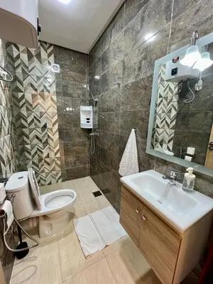 a bathroom with a toilet and a sink and a mirror at T1 Chic & Bright in Marrakech in Marrakech